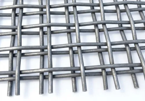 Detailed macro shot of high-manganese steel woven wire screen mesh showing precise crimp structure and durability